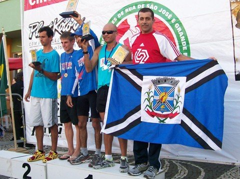 tubaronense-se-prepara-para-a-meia-maratona-no-rio-de-janeiro-1 Roberto sempre leva uma bandeira do município ao subir no pódio. Foto: Roberto Paes/Arquivo Pessoal/Divulgação/Notisul