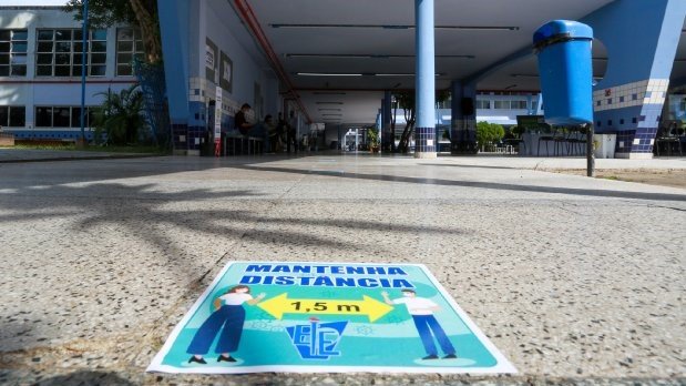 Aulas em Santa Catarina retomam dia 18 de fevereiro com atividades presenciais e ensino remoto #Pracegover Na foto, a entrada de uma escola e um tapete orientando distanciamento