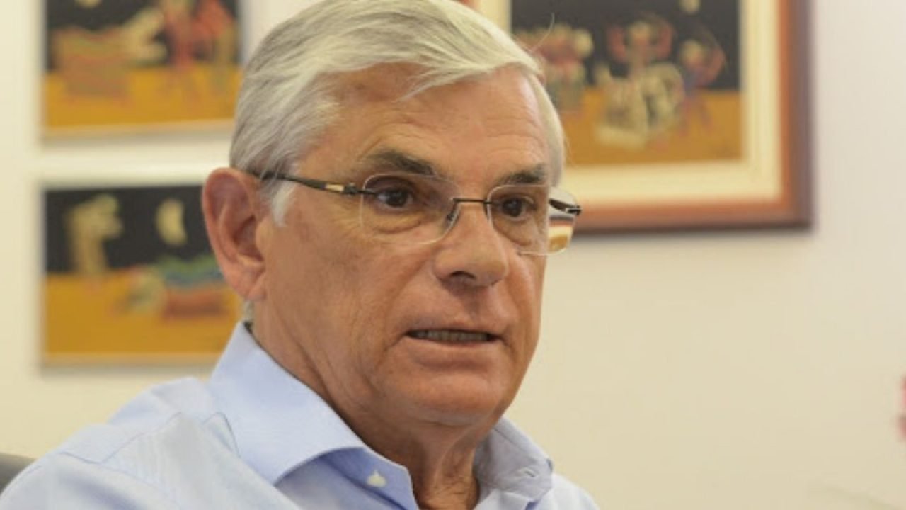 Eduardo Moreira #Pracegover Foto: na imagem há um homem de cabelos grisalhos, com camisa azul e de óculos. Há também uma parede com três quadros